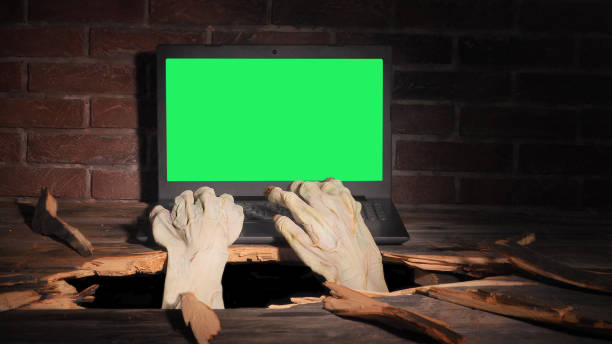 istock Zombie hand through hole cracked in rustic wood.Halloween theme 1278925011