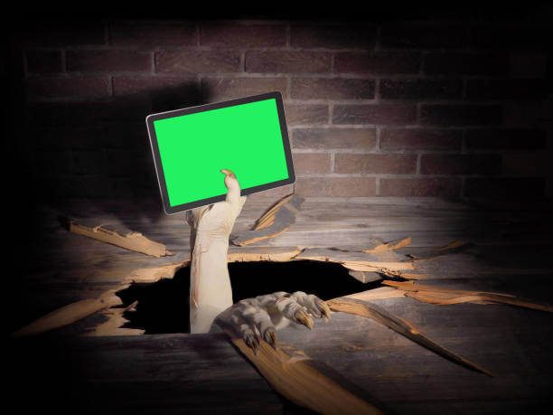istock Zombie hand through hole cracked in rustic wood.Halloween theme 1278925024