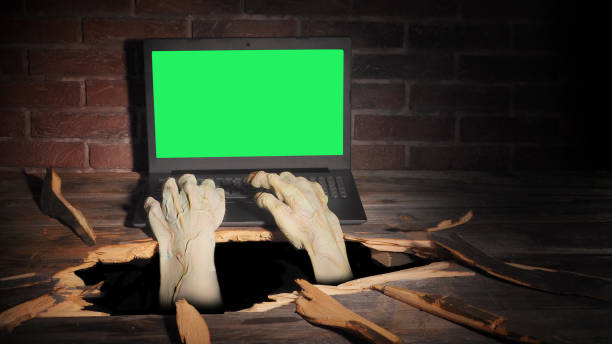 istock Zombie hand through hole cracked in rustic wood.Halloween theme 1278925061
