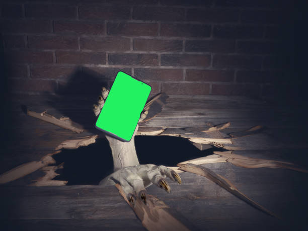 istock Zombie hand through hole cracked in rustic wood.Halloween theme 1278925067