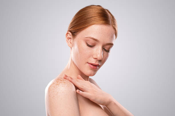 istock Young woman smearing cream on shoulder 1278927826