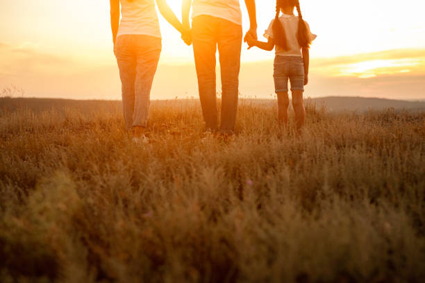 istock Unrecognizable family enjoying sunset in nature 1278927876