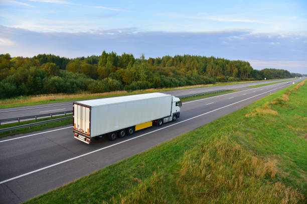 istock White truck with semi-trailer driving along highway 1278930144