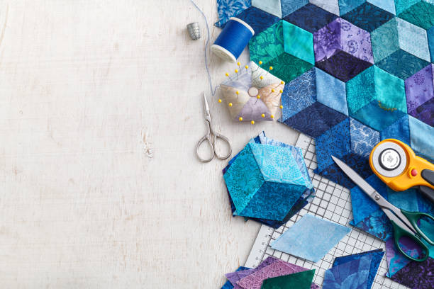 istock Fragment of tumbling blocks quilt, accessories for quilting on a white surface. Space for text. 1278931787