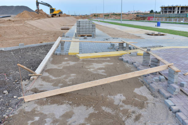 istock Installing paving bricks on patio at construction site. Laying paver slabs and brick, borders  in the pedestrian zone. 1278932012