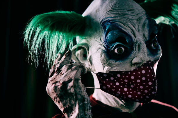 istock disturbing evil clown wearing a red face mask 1278932041