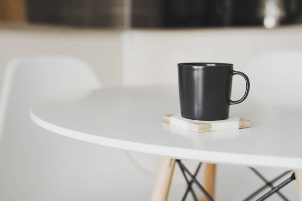 istock Empty black coffee mug stand on a marble coaster at the kitchen table 1278934059