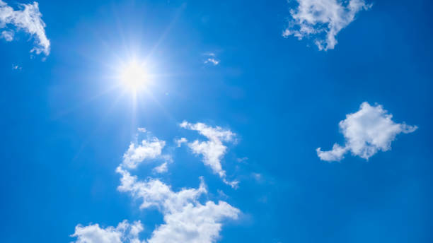 istock Thick clouds in a Sunny blue sky. The bright sun is peeking out visible through thick dense clouds 1278936283