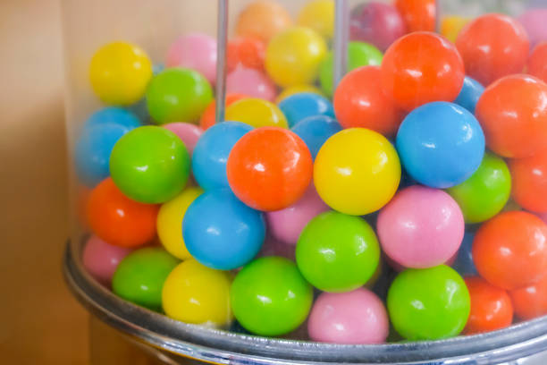 istock Chewing gum machine. Transparent container box with multi-colored chewing gum spherical shape. 1278936425