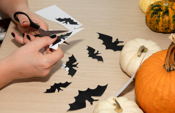 istock A man carves bats as decorations for a Halloween party. 1278937049