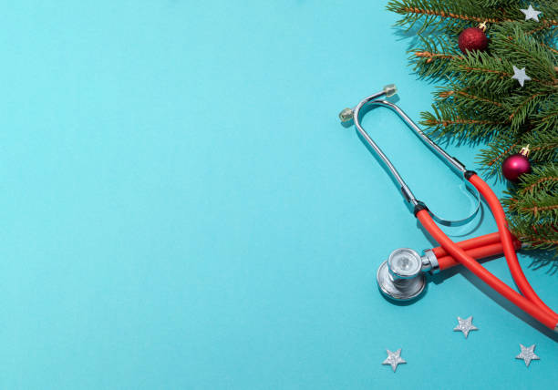 istock Phonendoscope with Christmas decorations, stars on a blue background. Banner with space for text. Congratulations to medical professionals on the New year and Christmas. 1278937179