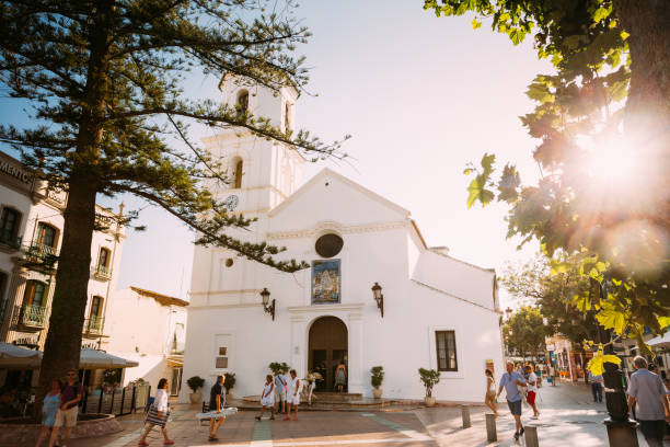 people walking near church of el salvador in nerja, spain - nerja imagens e fotografias de stock