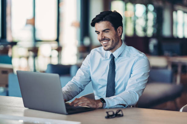istock Smiling businessman working in the office 1278937761