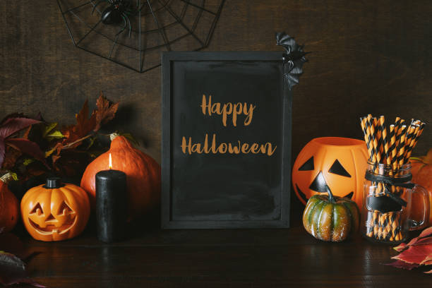 istock Halloween party background with pumpkins, , web, spooky spider. Text - Happy Halloween on chalkboard. 1278938487