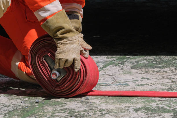 Firefighters and Fire hose coil  fire and rescue training school regularly to get ready - help, fire protection concept