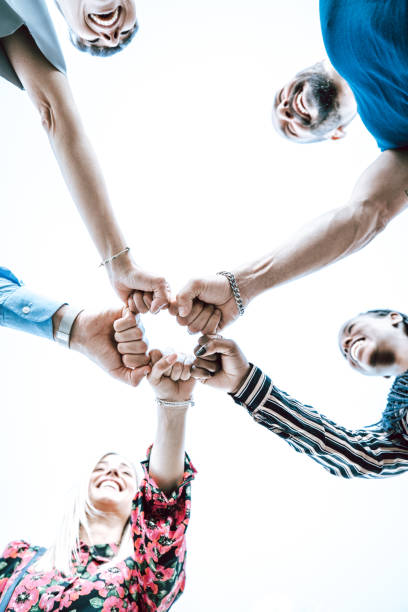 istock Group of young adults join their hands together 1278943660