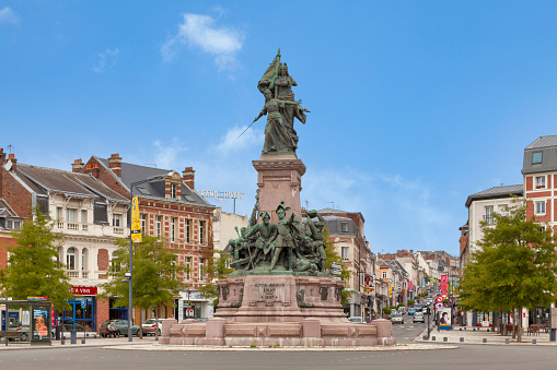 Saint-Quentin, France - June 10 2020: The monument commemorating the siege of the city of Saint-Quentin in 1557 is an achievement by the architect Heubes and the sculptor Theunissen. It was inaugurated on June 7, 1897 on the Place de l'Hotel de Ville, then transferred in 1998 to its current location, in the center of the Place du 8 octobre.
