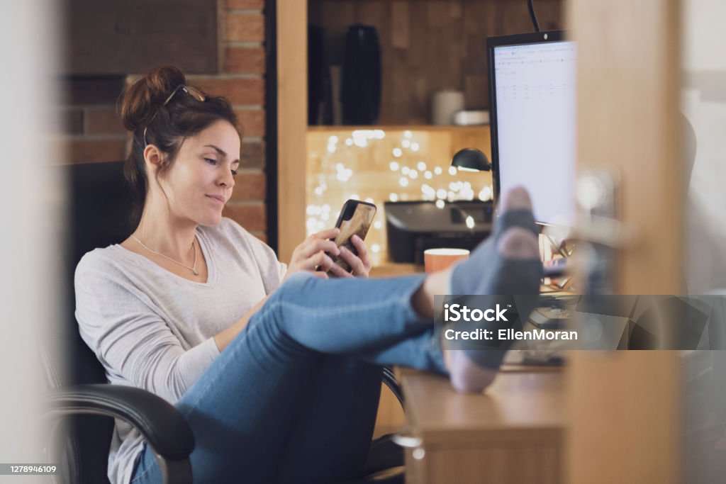 Home Office Coffee Break A woman is working from a home office.  A woman is taking a break from work. One Woman Only Stock Photo