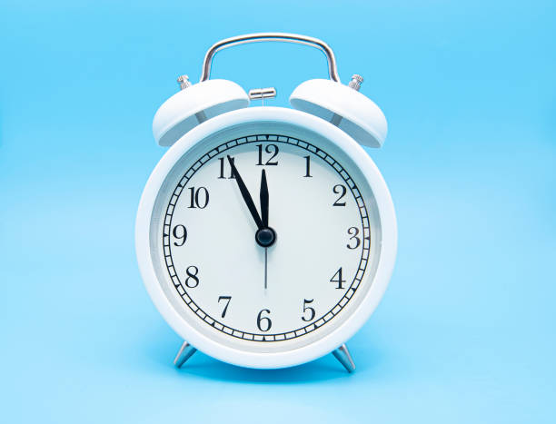istock White classic alarm clock on blue background, concept picture 1278947562