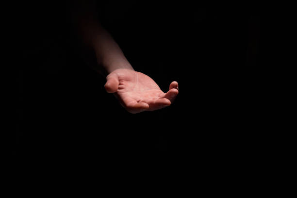 istock Support hand on a dark background. Helping hand from the dark 1278949064