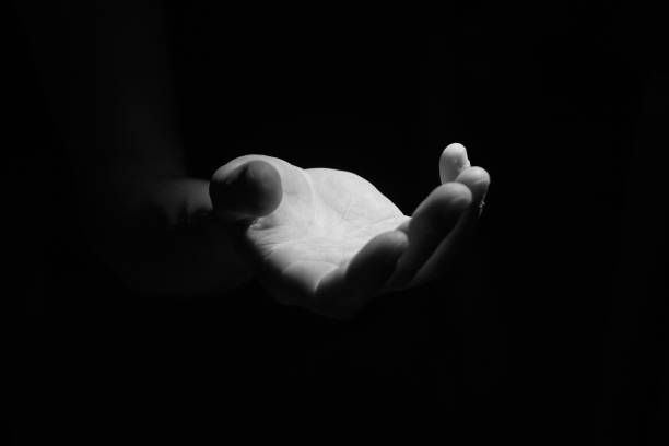 istock Support hand on a dark background. Helping hand from the dark 1278949067