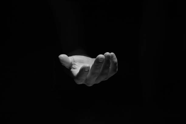 istock Support hand on a dark background. Helping hand from the dark 1278949070