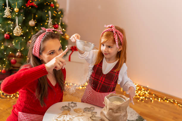 istock Mother and daughter having fun making Christmas cookies 1278951082