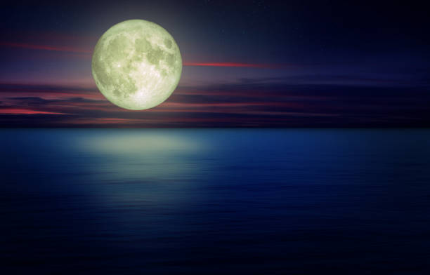 istock Full Moon with dark cloud in night sky and seascape view in background. 1278951250