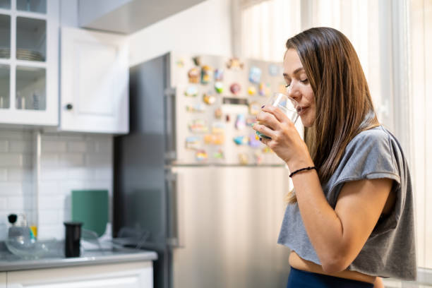 istock Young woman drinking healthy detox in kitchen 1278951536