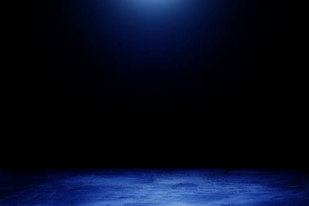 istock Studio dark room concrete floor texture background with blue lighting effect. 1278951623