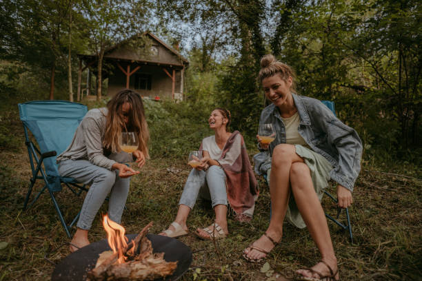 istock Young women sitting by campfire 1278953029