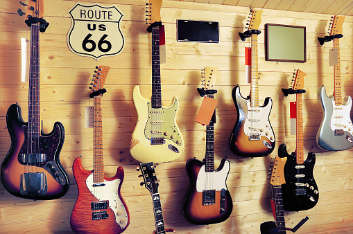 Electric guitars hanging on wall in music store.