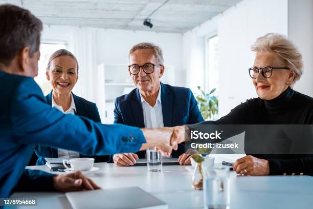 Senior Business People During Meeting Stock Photo - Download Image Now - Navy Blue, Senior Men, Handshake