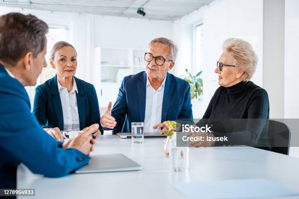 Senior Business People During Meeting Stock Photo - Download Image Now - Corporate Governance, 65-69 Years, 70-79 Years
