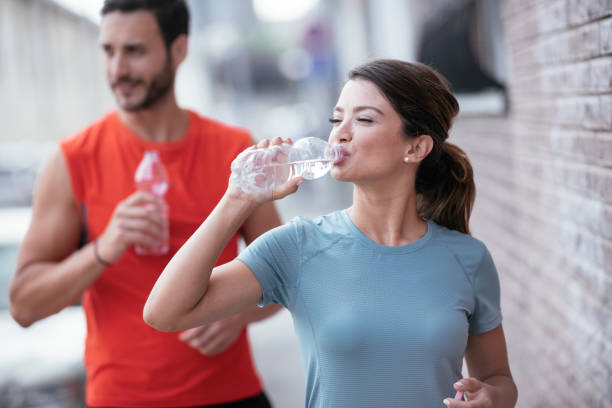 istock Woman drinks water after running. 1278955685