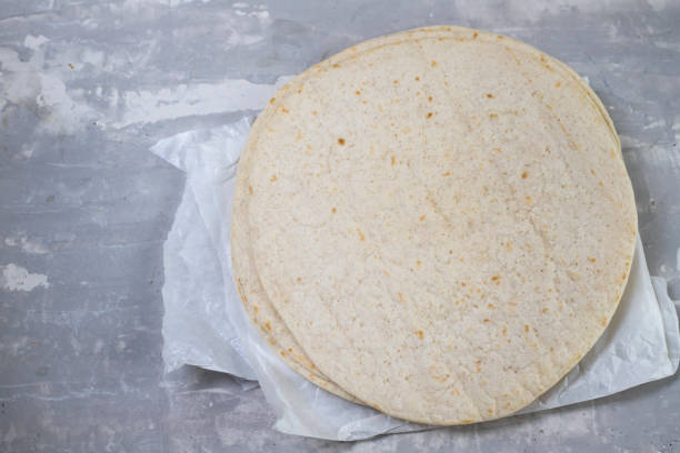 istock tortilla on white paper on ceramic background 1278955790