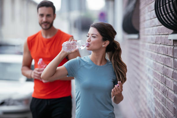 istock Woman drinks water after running. 1278955873