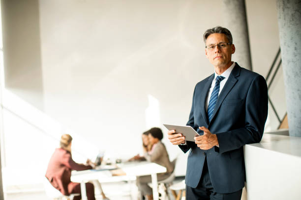 istock Handsome businessman using his tablet in the office 1278957015