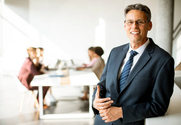 istock Handsome business man standing in the office 1278957022