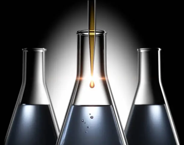 Three Erlenmeyer flasks with pipette and drop, dark background