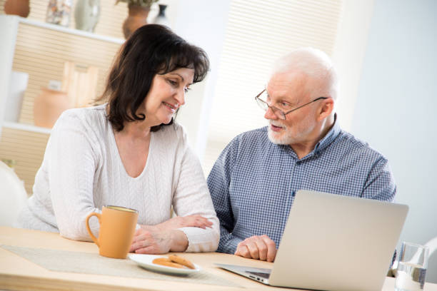 istock Happy elderly couple shop online together 1278962080