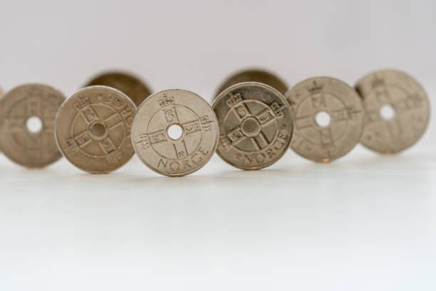 istock Norwegian Kroner coins standing on a white table. 1278963678