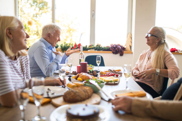 istock Senior friends having fun time during lunch at home 1278964311