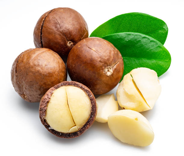 istock Macadamia nuts with peeled macadamia and leaves isolated on a white background. 1278966953
