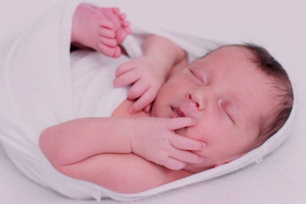 istock Newborn sleeping baby in a beautiful bed sheet posing 1278968673