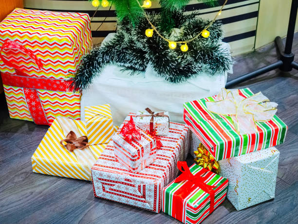 istock Christmas gifts in boxes with patterned wrapping rewound ribbons lie on the floor 1278972596