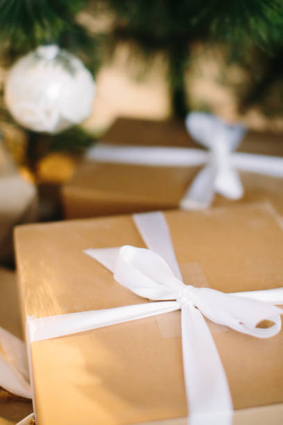 istock Gift wrapped in kraft paper lies under Christmas tree. Selective focus. 1278973740