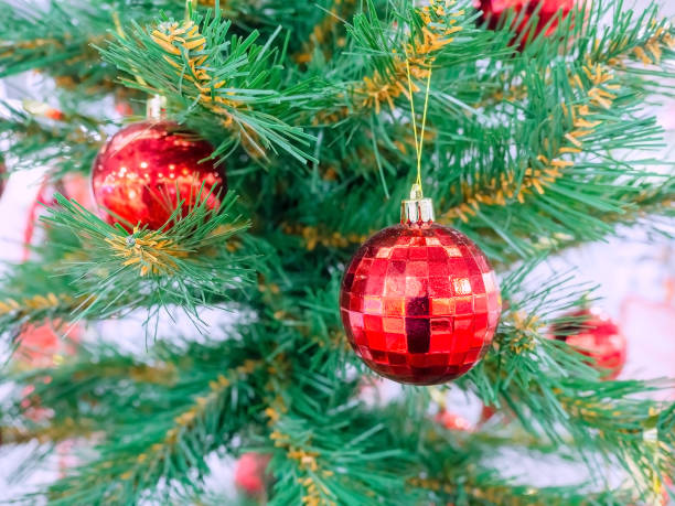 istock Red glossy balls hang on the New Year tree. Focus to the foreground 1278973776