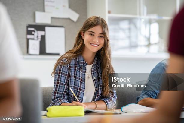 Download Smiling College Girl Studying In Classroom Stock Photo