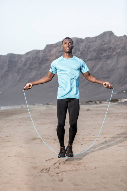 istock Black man jumping with rope on beach 1278974015